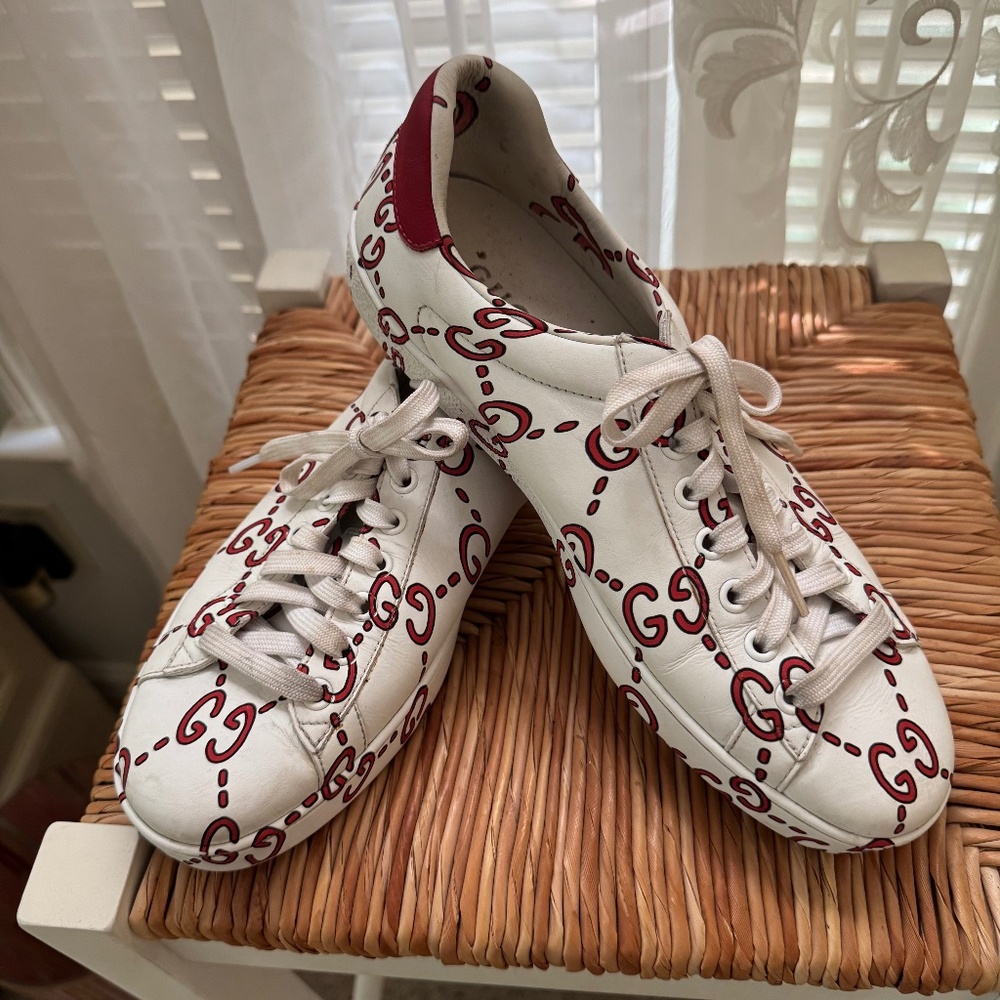 Gucci athletic shoes in a red and white logo print